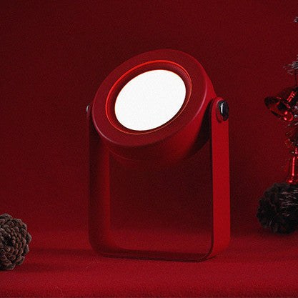 Red portable lantern lamp on a red background, USB rechargeable and compact.