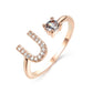 Adjustable initial letter ring with zircon stones, elegant design for women.