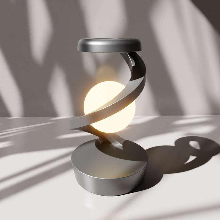 Rotating hanging mobile phone wireless charging lamp with modern design.