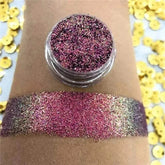 Chameleon eyeshadow with shifting colors in a glittery swatch on arm.