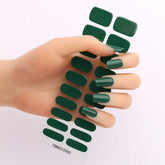 Gel nail stickers in deep green shade displayed on a hand with semi-curing and hardening features.