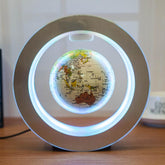 Floating world map globe with LED lighting, showcasing gravity-defying technology in a sleek silver frame.