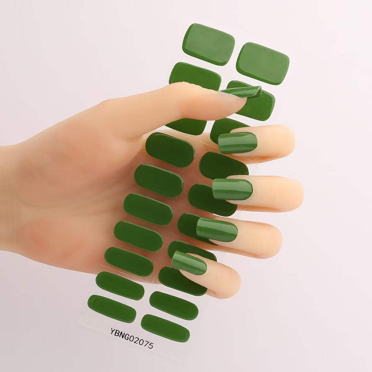 Gel nail stickers in green shade displayed on a hand.