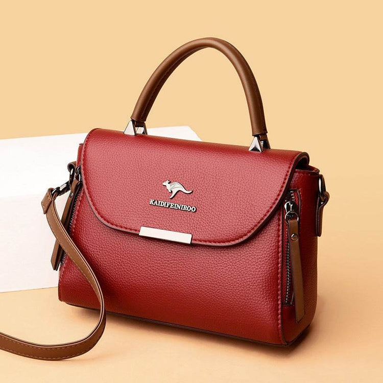 Fashionable stylish women's crossbody shoulder bag in red leather with single strap.