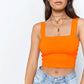 Fluorescent orange sleeveless crop top for women made of polyester and acrylic.