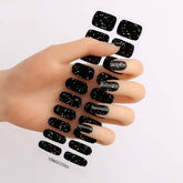 Gel nail stickers with black starry sky pattern applied on nails.