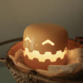 Pumpkin Lamp Bedside with a cozy glow in wicker basket.