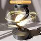 Rotating hanging mobile phone wireless charging lamp with light display.