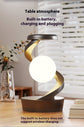 Rotating hanging mobile phone wireless charging lamp on wooden table.