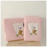 Cute pink laptop sleeve with cartoon bear design for women, offers protection for tablets and laptops.