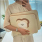 Women holding a cute laptop sleeve case with cartoon design, suitable for various laptop sizes.