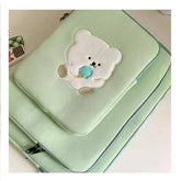 Cute green laptop sleeve case with a cartoon bear design, ideal for women&