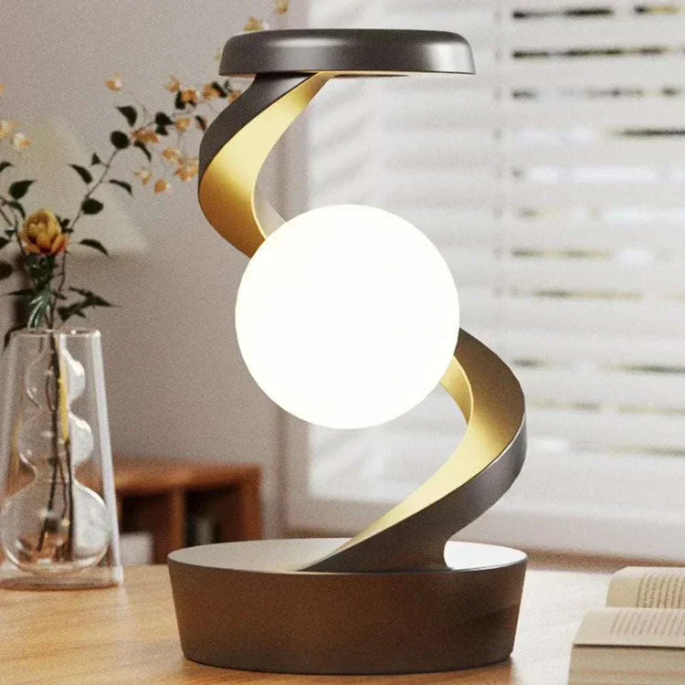 Floating moon table lamp with a modern, rotating design for bedrooms.