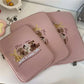 Pink cartoon laptop sleeves for women, featuring cute animal designs and zipper closure, suitable for 11-15.6 inch devices.