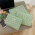 Cute green gingham laptop sleeve cases for women on a table with a laptop and flowers.