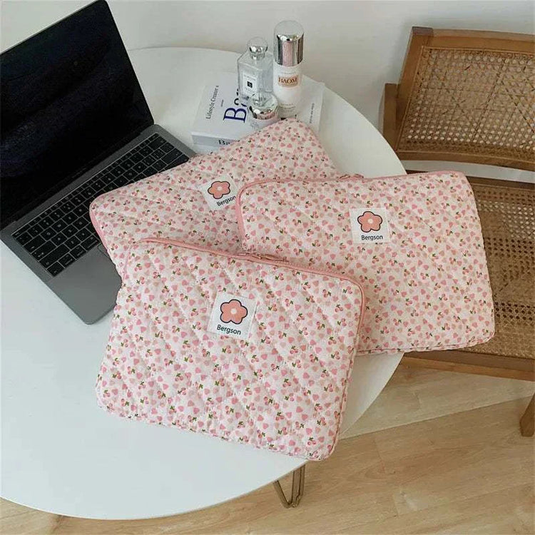 Women cute laptop sleeve case with floral design on table.