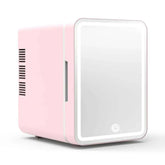 Mini skincare fridge with mirror in pink, compact design for beauty storage.