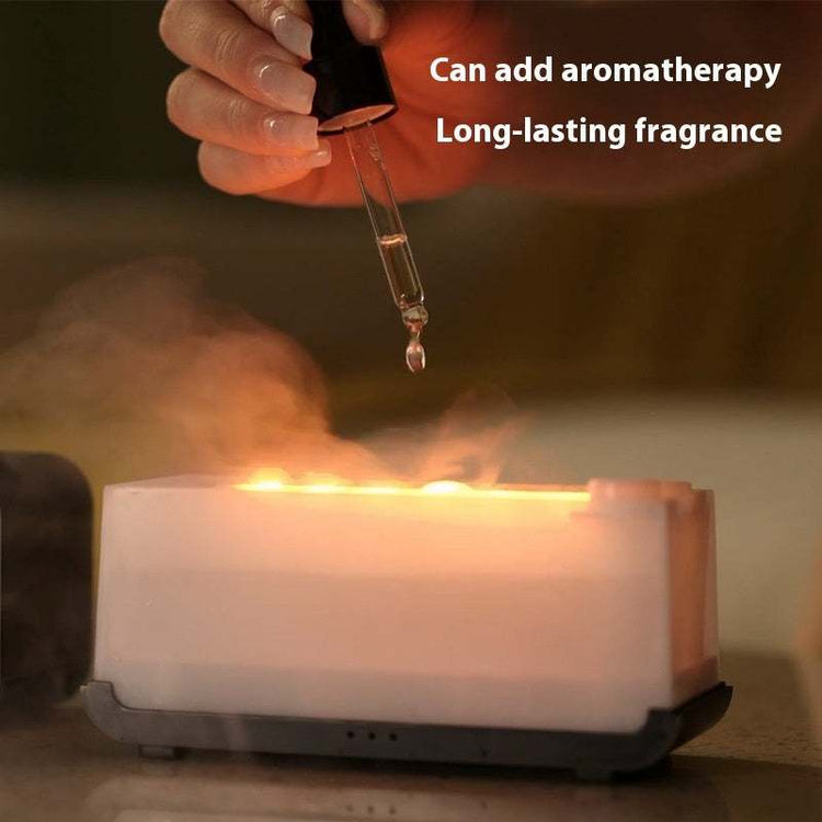 Flame effect aromatherapy humidifier diffuser with droplet applicator.