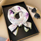 Fashionable stylish artificial silk ornament scarf hair band with floral pattern in a gift box.